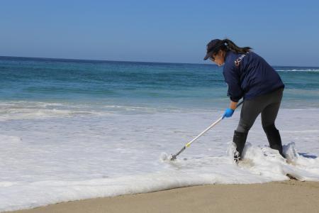 Woman testing ocean water